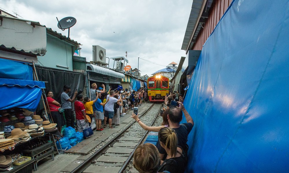 Maeklong Railway Market train along the tracks