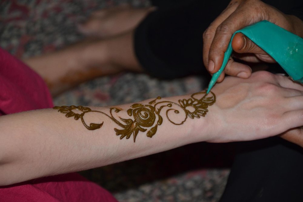 henna applied on arm in dubai desert