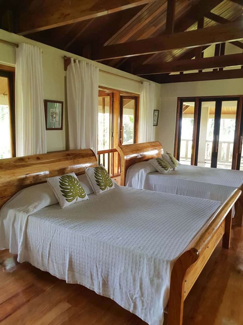 two beds in wooden bedroom