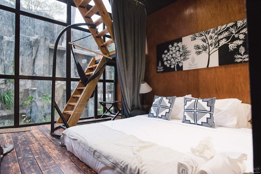 cozy bed next to wooden stairs