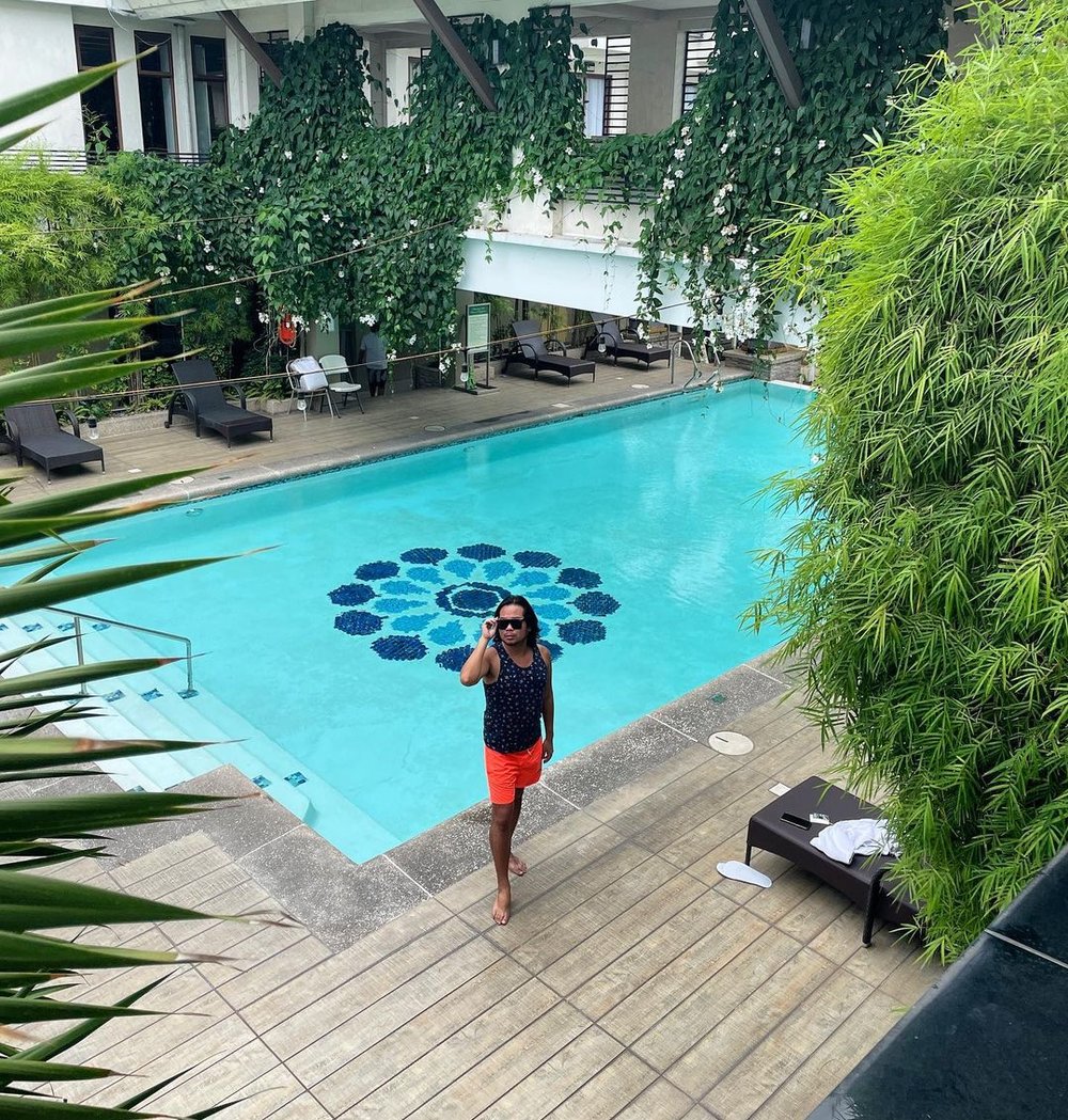 guy in sunglasses next to pool