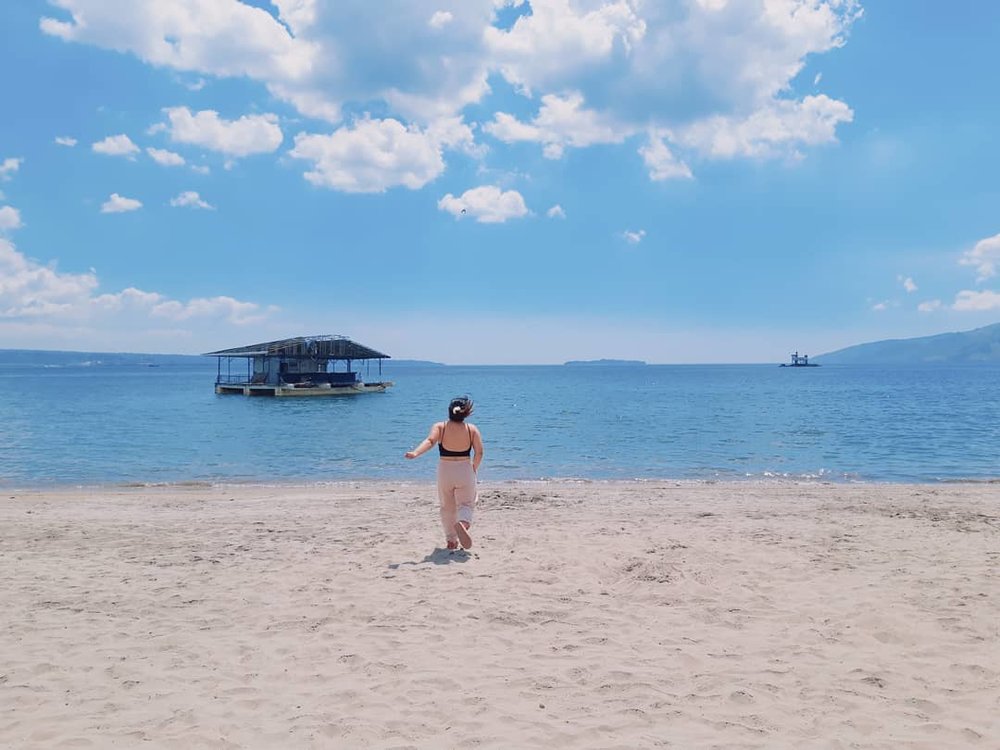 girl walking by beach shore