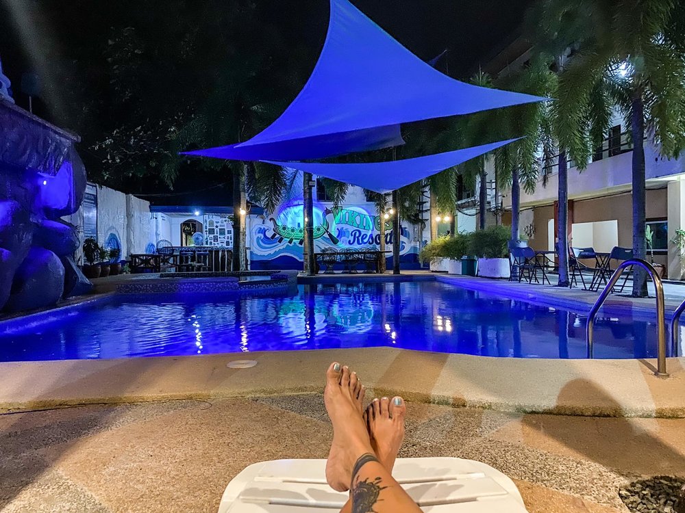 feet crossed on pool lounge bed