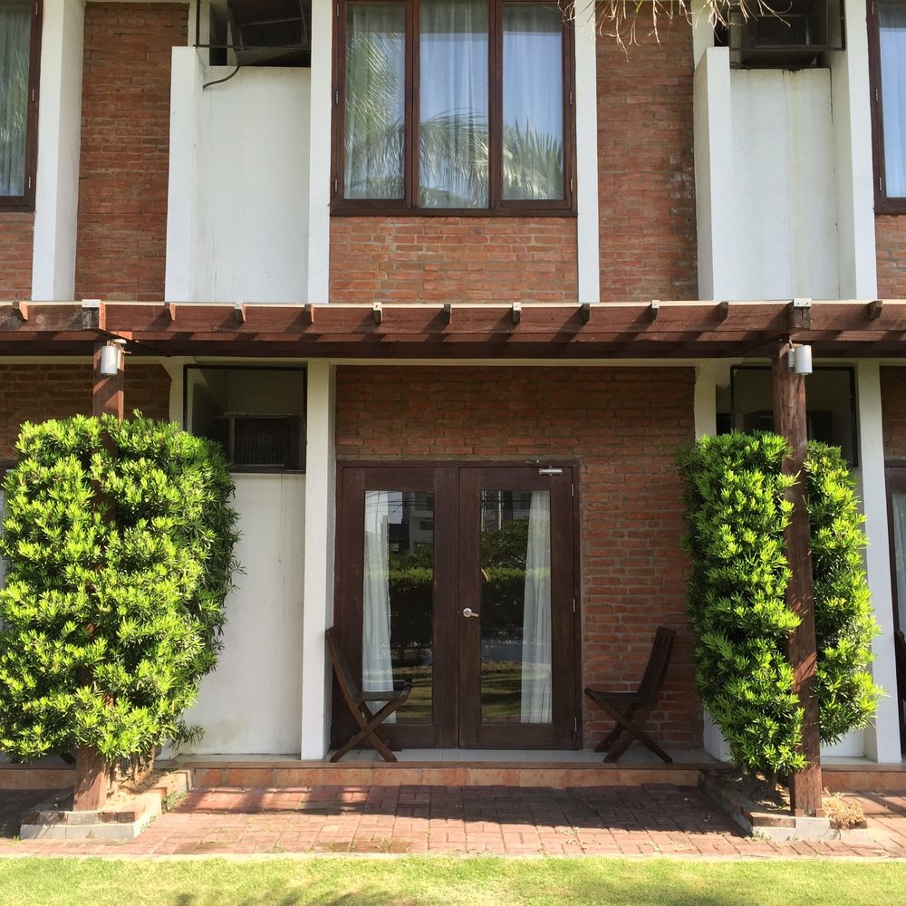 wooden patio door with two folding chairs