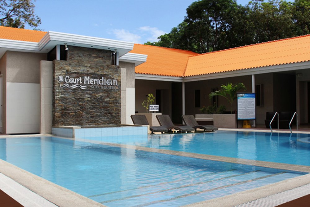 pool with hotel sign on wall