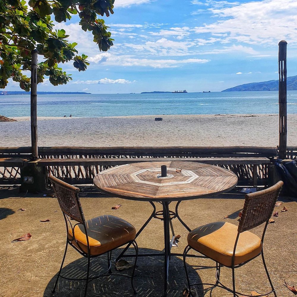 outdoor table and chairs overlooking sea
