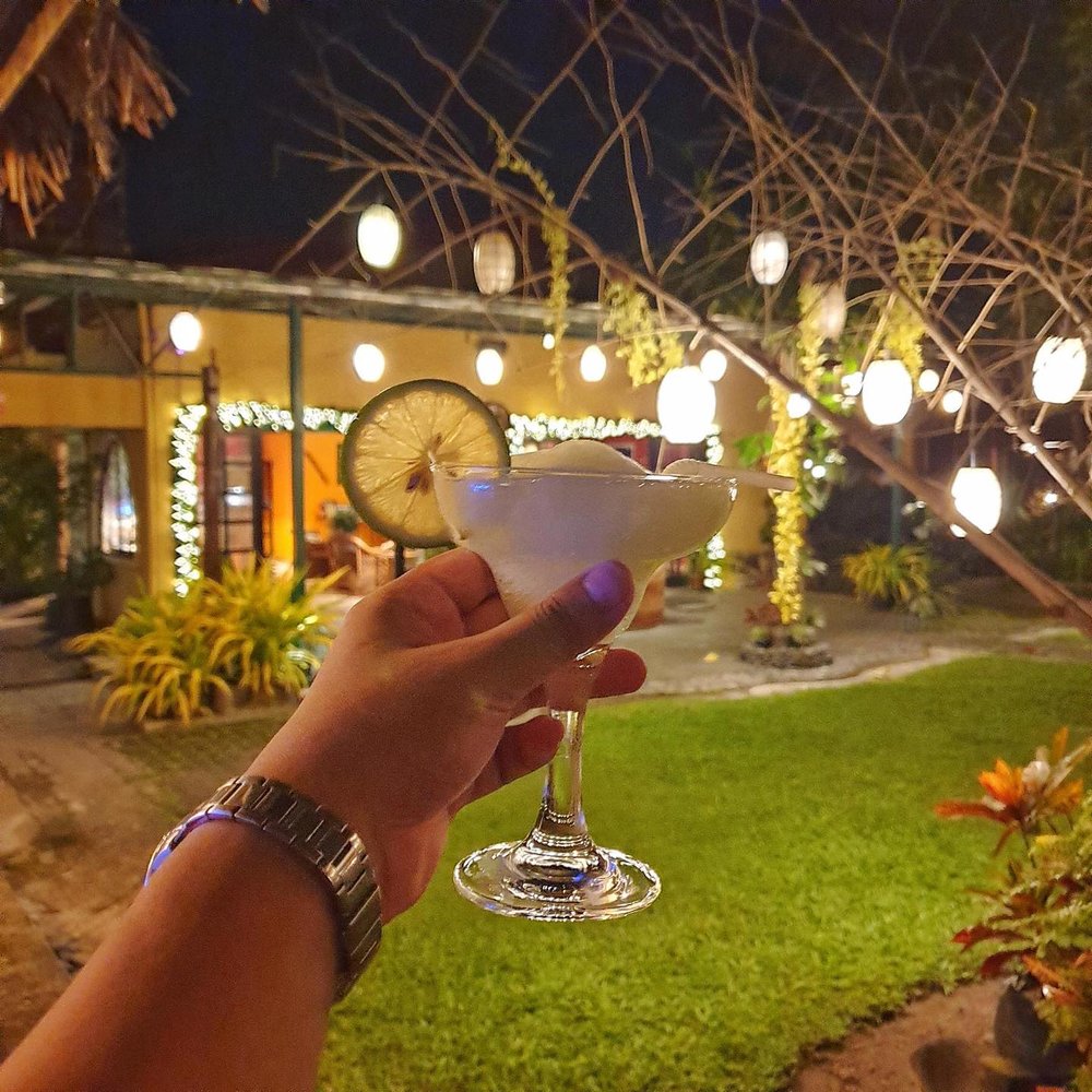 margarita cocktail in hand