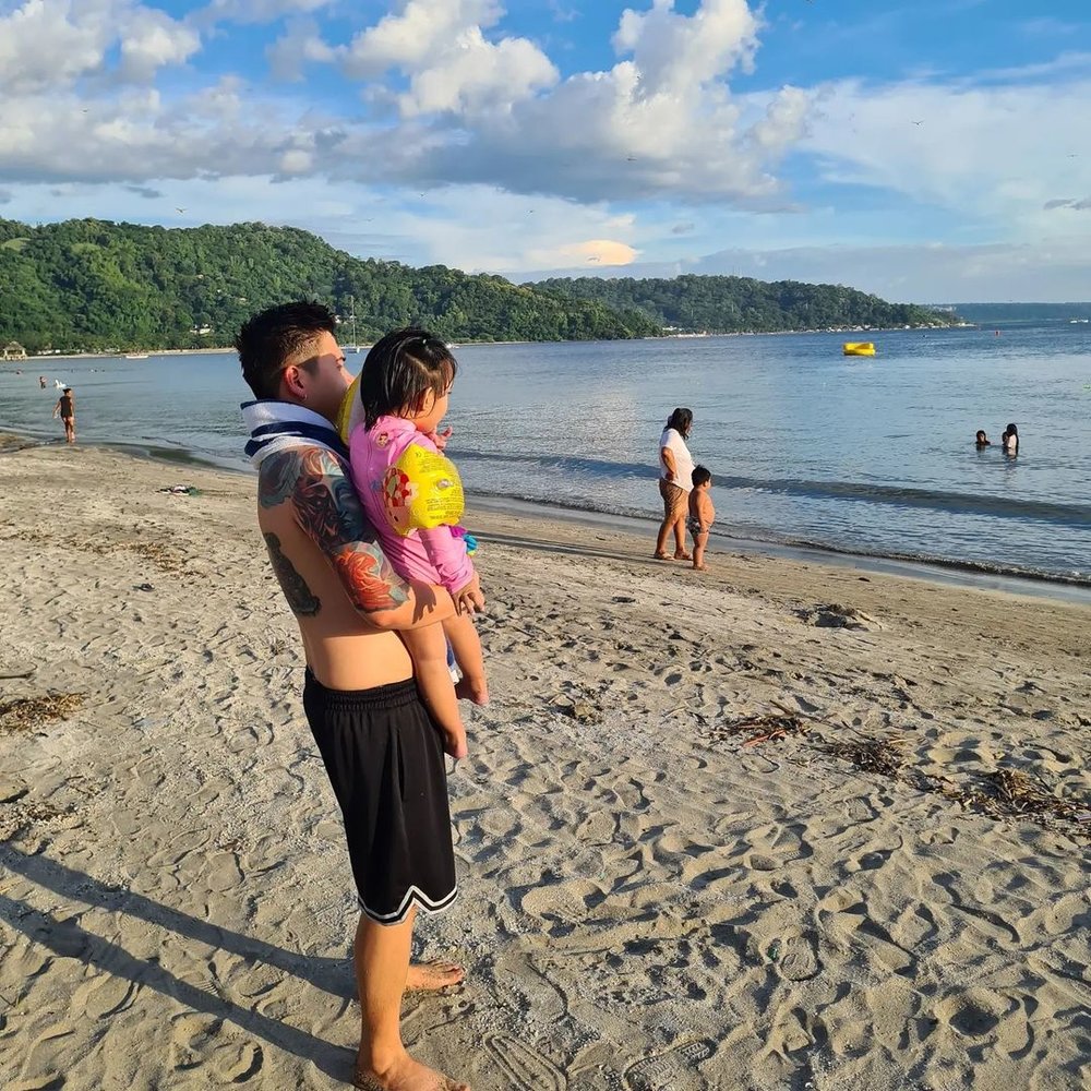 dad and daughter by shore