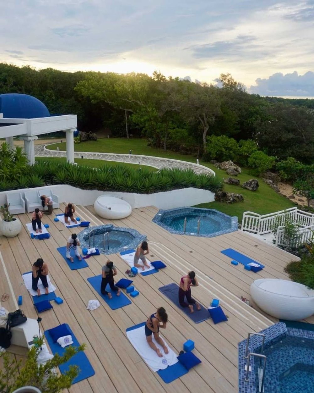 women doing a group yoga class by veranda