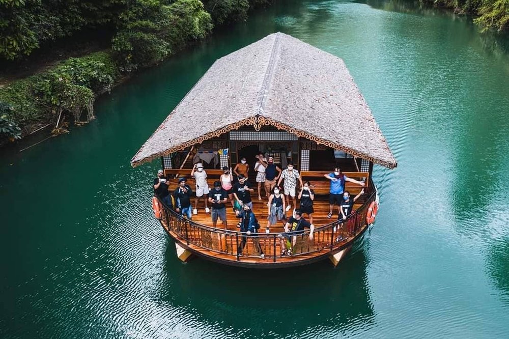 drone shot of people in floating restaurant