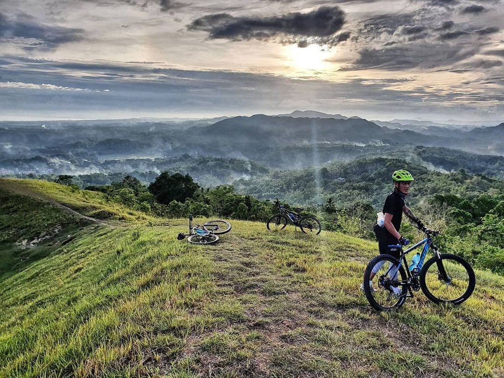 man holding bike in mountain