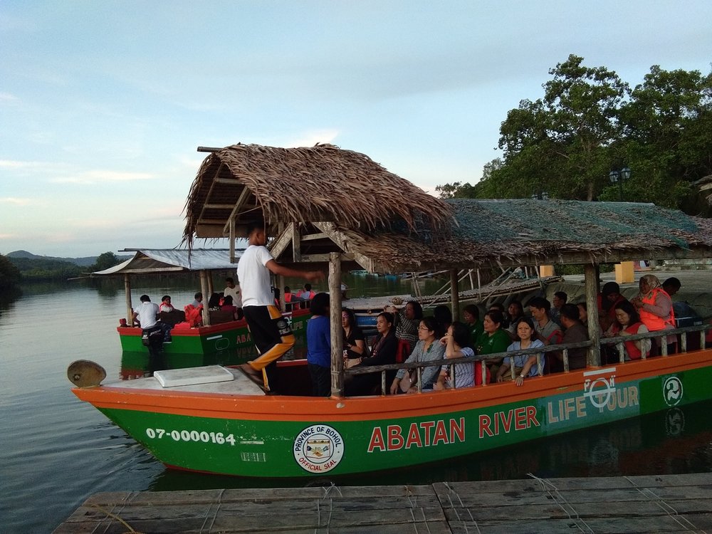 people inside boat in a river