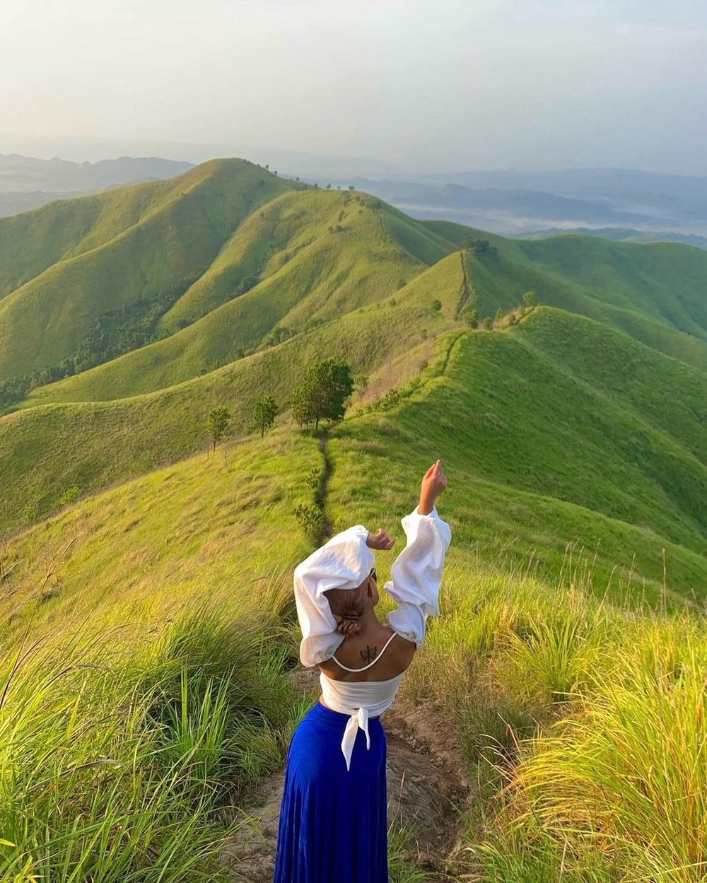 girl posing on top of mountain
