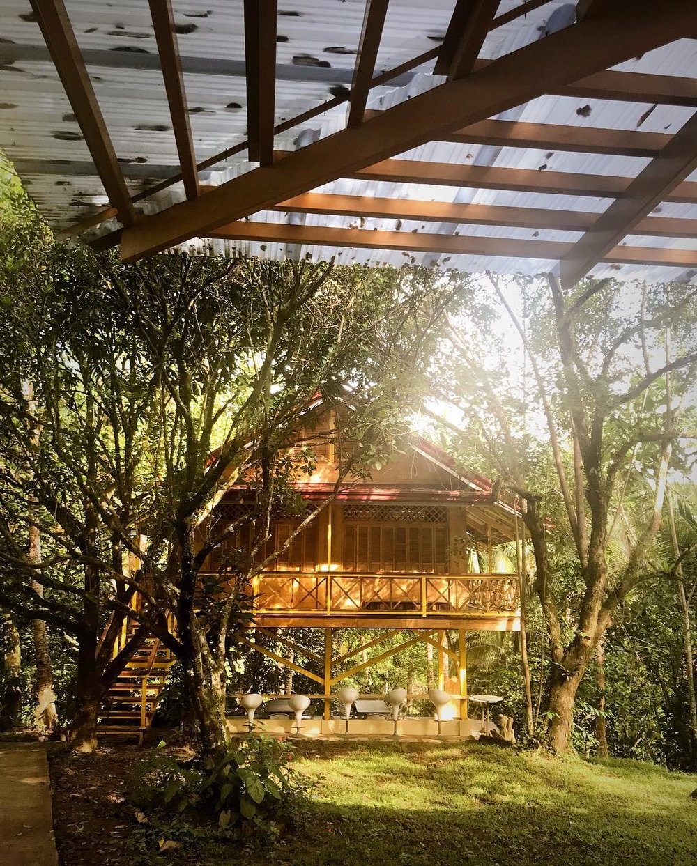 wooden rest house with a lush garden