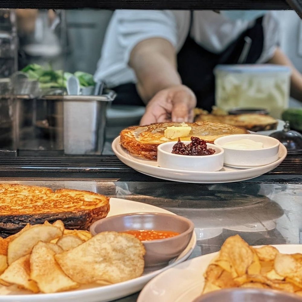 chef handing plate of food
