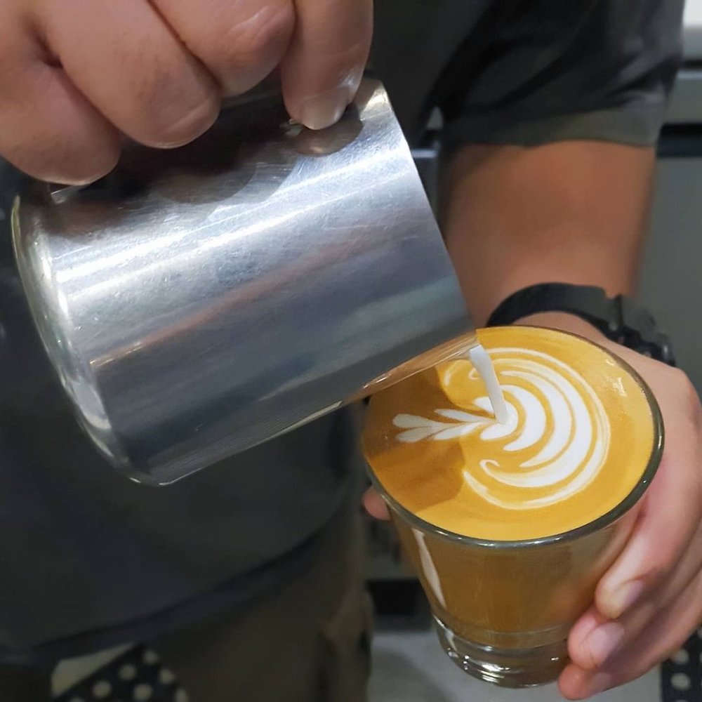 barista making latte art in cup