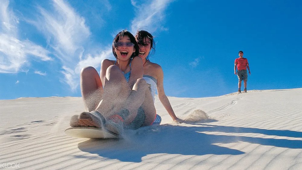 Try your hand at sandboarding! Go with a partner for more fun!