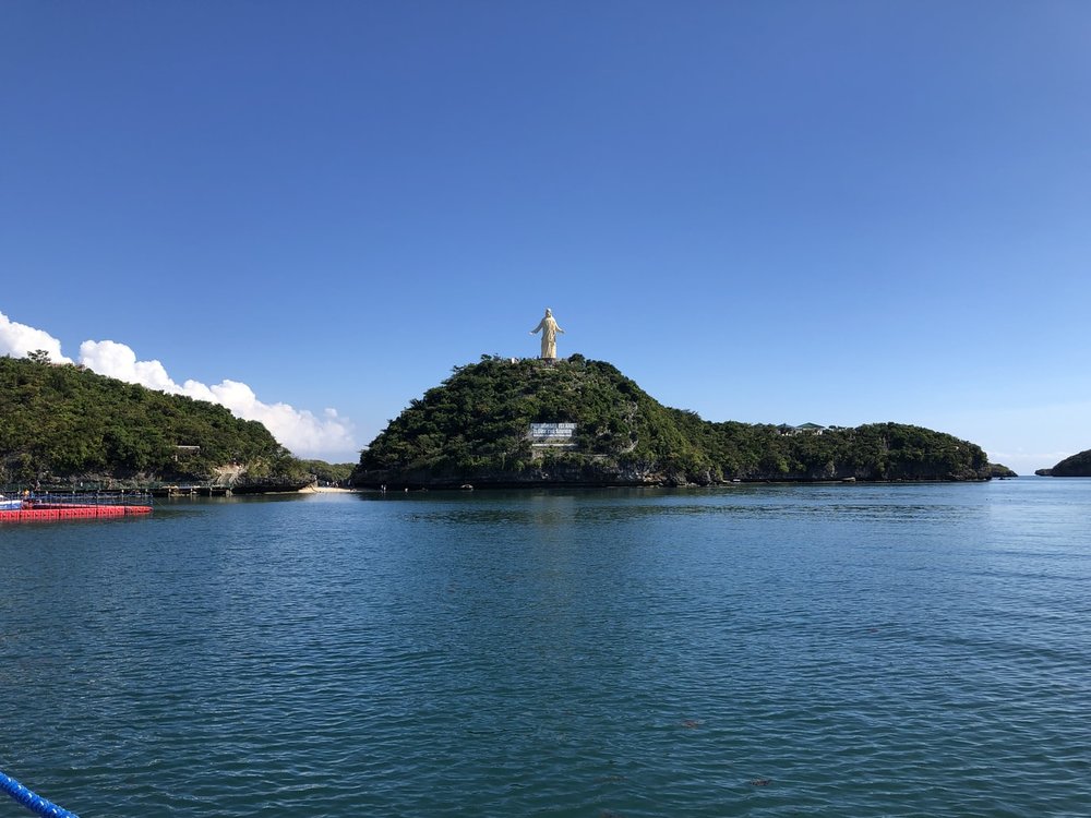 giant jesus statue on top of island