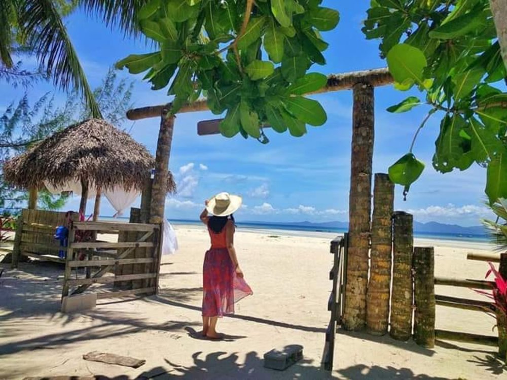 girl looking at ocean from beach shore