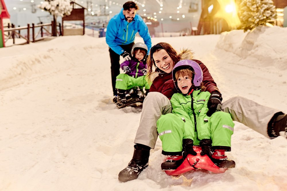 family playing in the snow at ski dubai