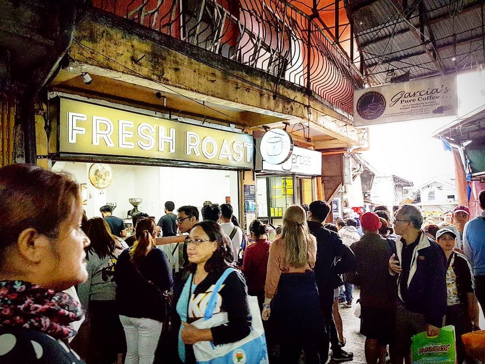 busy market with big coffee sign
