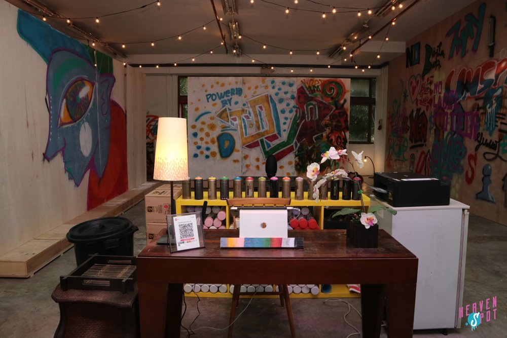 Sample graffiti on wall and materials for the graffiti workshop