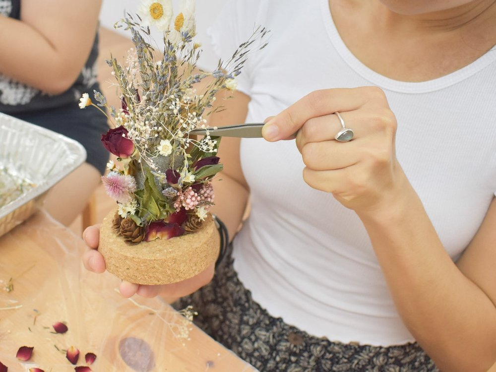 Participant working on a dried flower dome