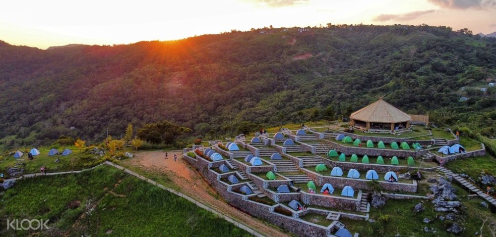 cliff with tent spaces during sunset