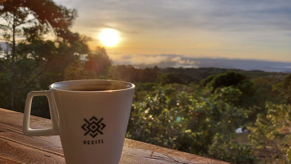 cup of coffee by bar table overlooking mountain