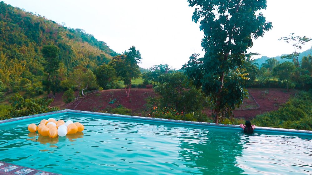 infinity pool with girl overlooking view