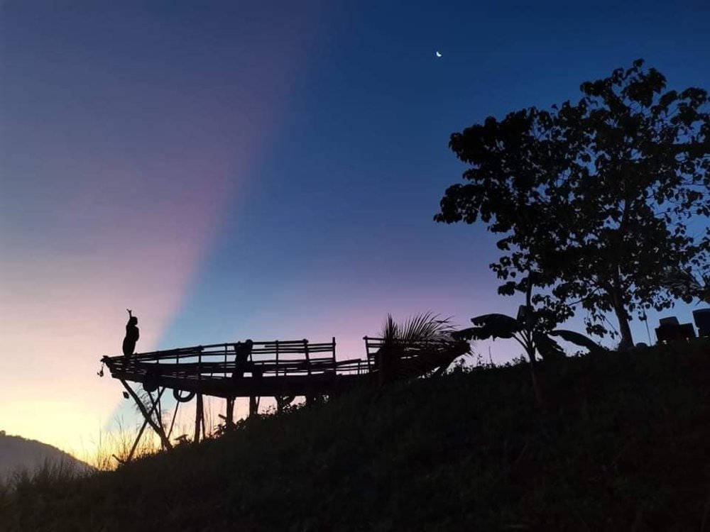 boat on stilts and girl silhouette at night
