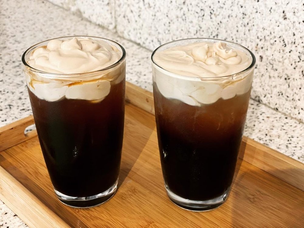 two coffee drinks with cream topping