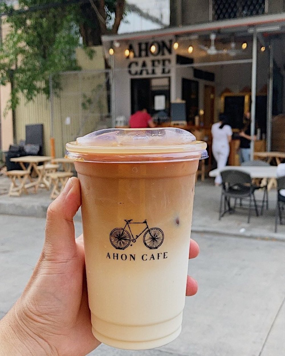 hand holding an iced coffee