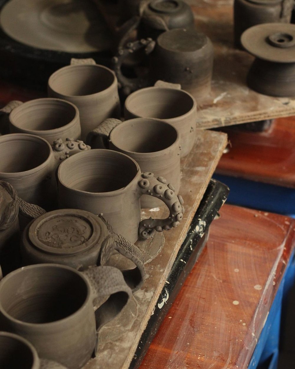 gray colored clay pots with different handles