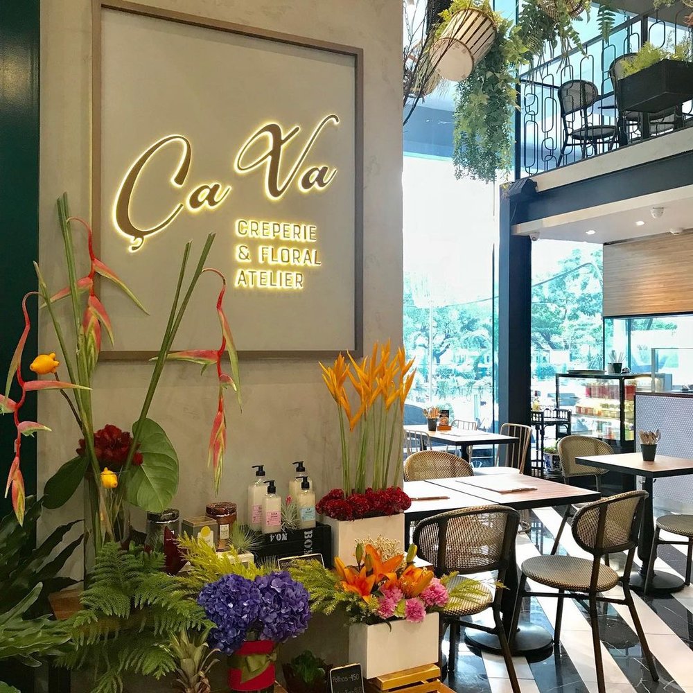 restaurant sign on wall with flowers