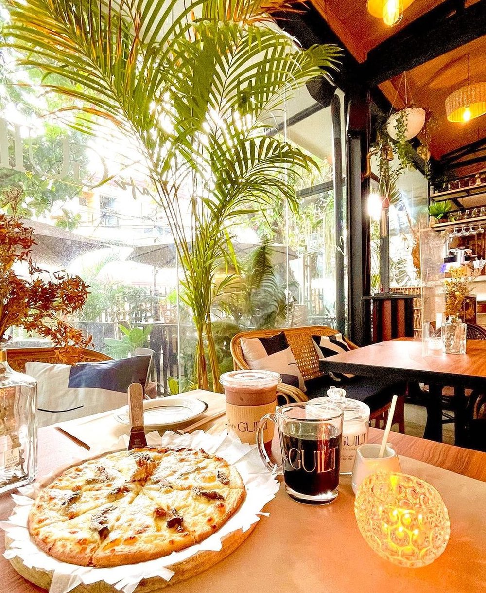 pizza and coffee drinks on table