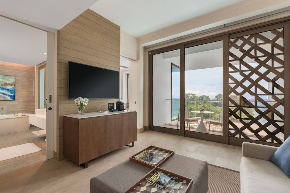 hotel room living room with television and big windows