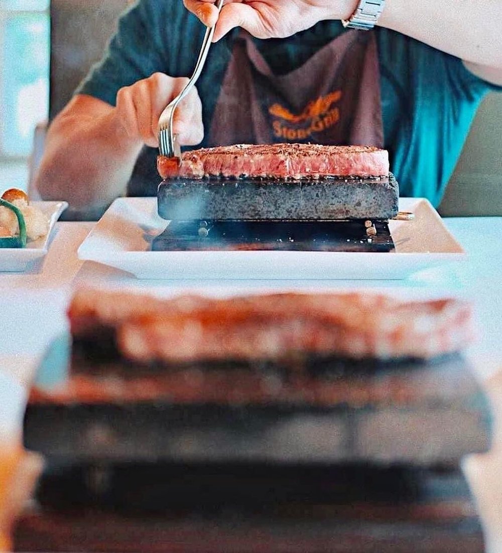 steak cooking on hot stone