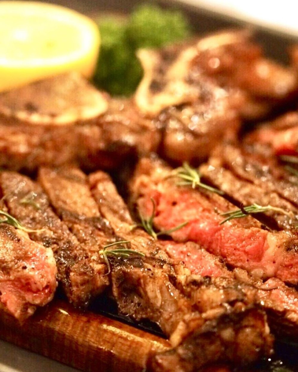 close up shot of  steak on wooden plate