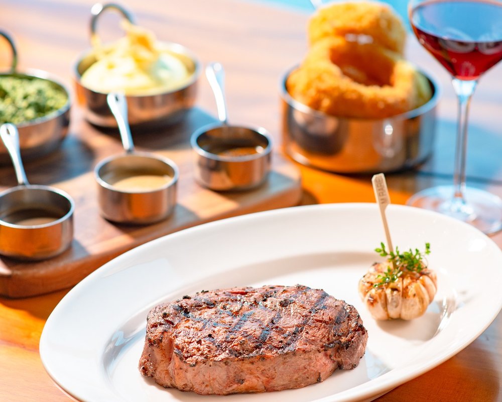 steak with roasted garlic  on wooden baord