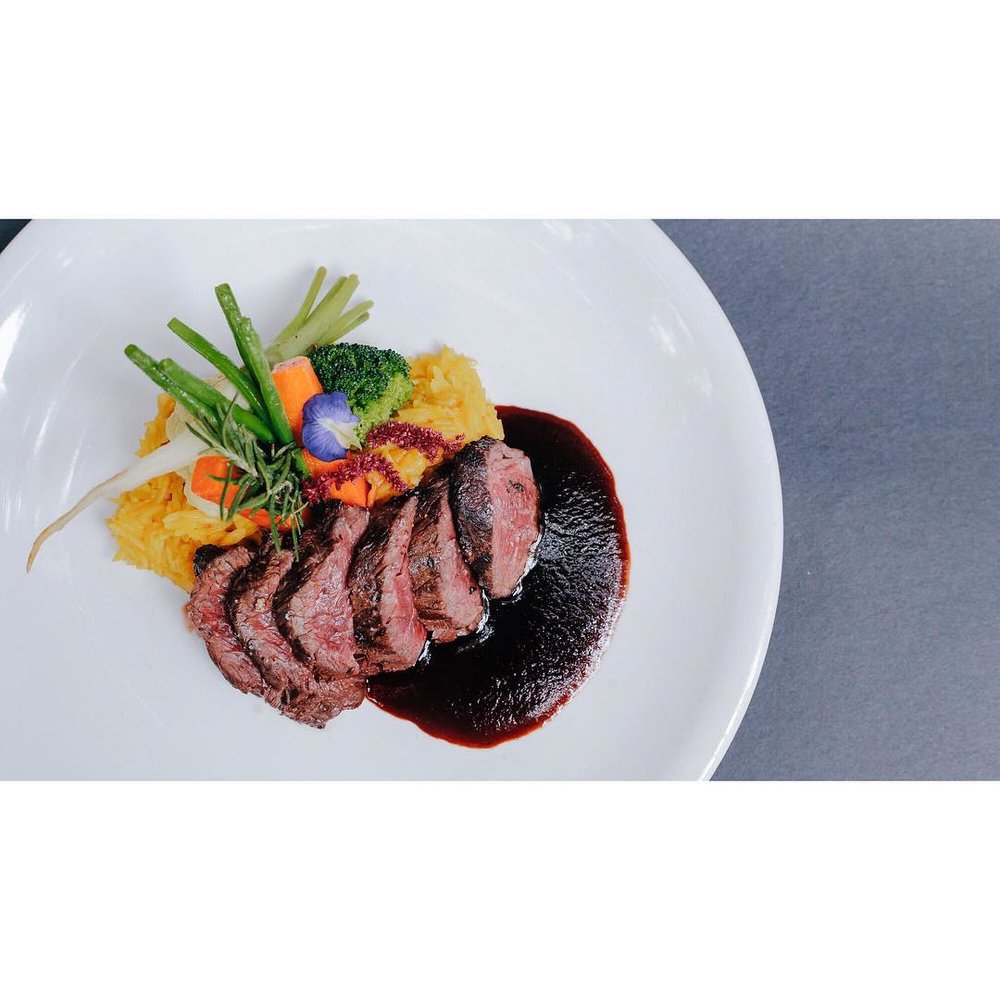 steak slices plated with pumpkin and vegetables