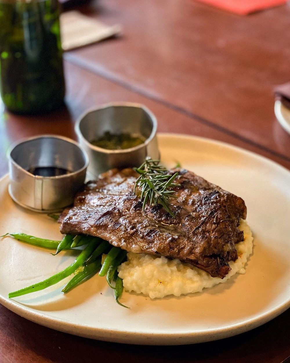 ribs on top of mashed potatoes and asparagus