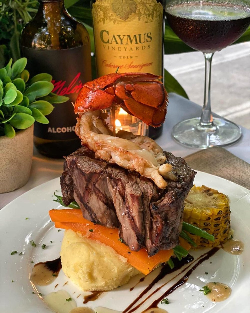 plate with mashed potato, thick steak slab, and skinned prawn 
