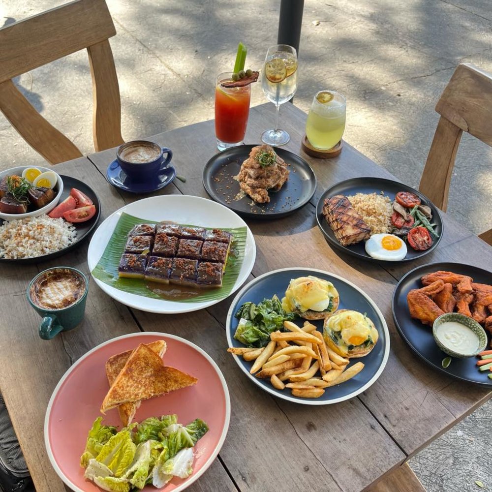 table with different plates of food and drinks