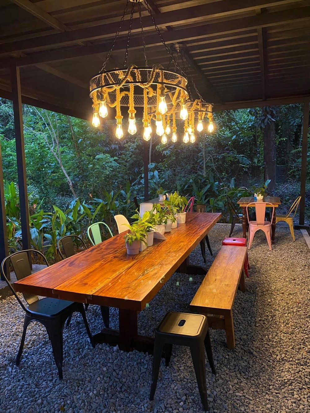 outdoor wooden table and lit chandelier