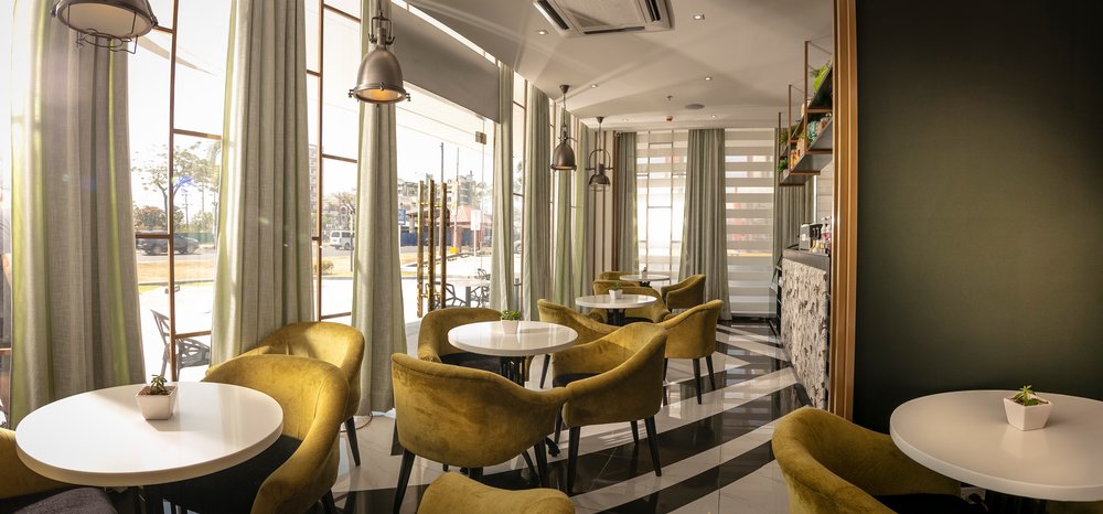 restaurant with green chairs and striped floor