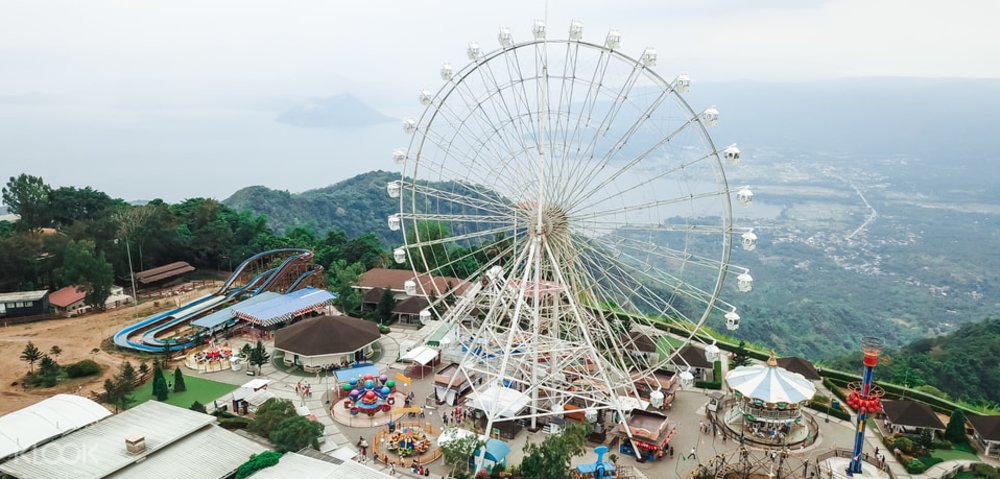 aerial shot of ferris wheel by lake