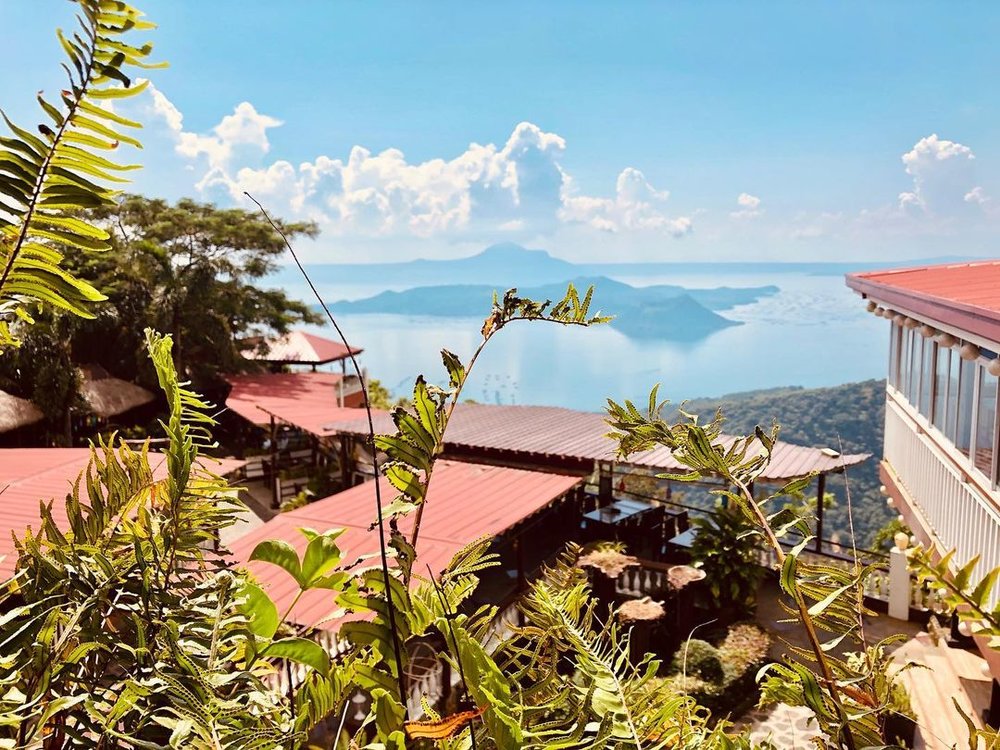 aerial shot of red roof and taal lake