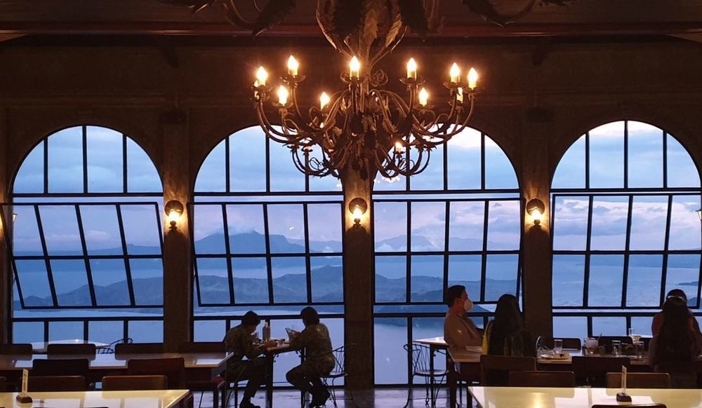 glass window overlooking taal lake and volcano