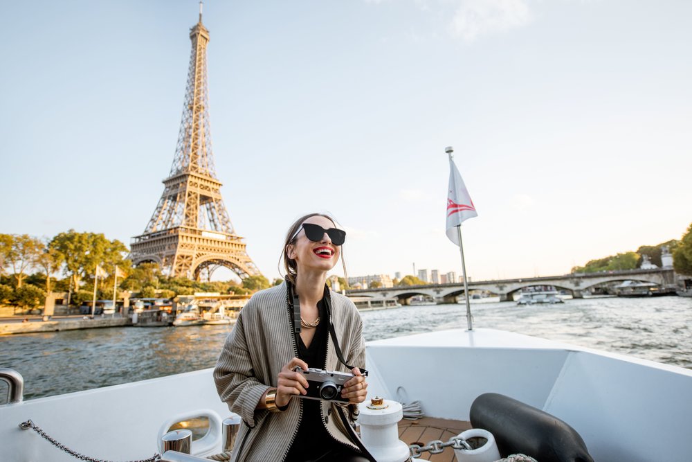 a woman on the river seine aperitif tour in paris